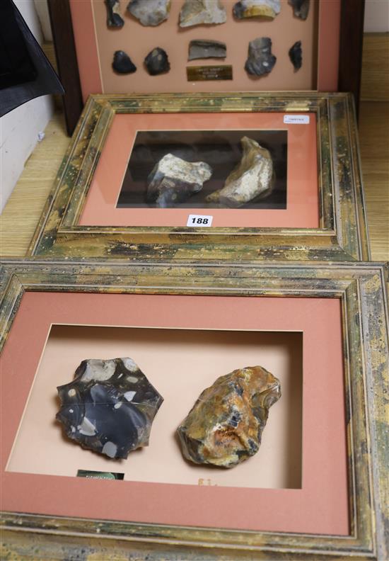 A framed display containing a Paleolithic Henley Pit chopper core and Moortown Pit handaxe and two other displays,